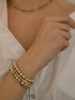 Bracelet on an elastic band with khaki cubic zirconia and natural pearl